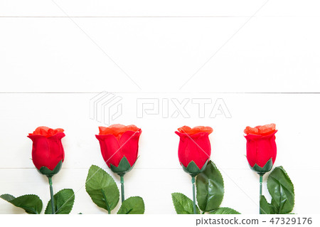 Present gift with red rose flower on wooden table Present gift with red rose flower on wooden table 47329176