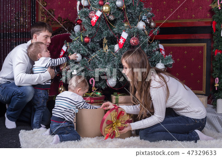Family decorating Christmas Family decorating Christmas 47329633