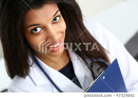 Beautiful black smiling female doctor at 47329892
