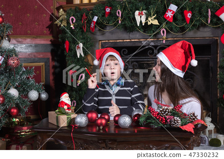 mother and son writing letter to Santa 47330232