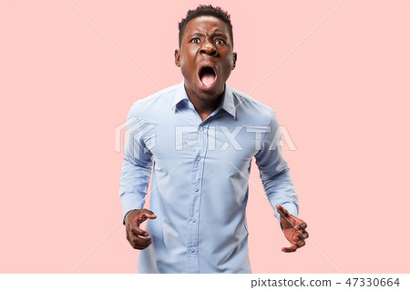 The young emotional angry man screaming on pink studio background The young emotional angry man screaming on pink studio background 47330664