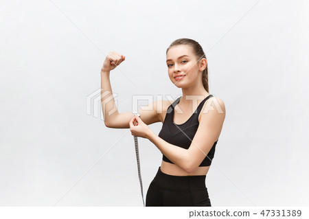 Happy slim woman with measuring tape on color background. Positive weight loss diet results. 47331389