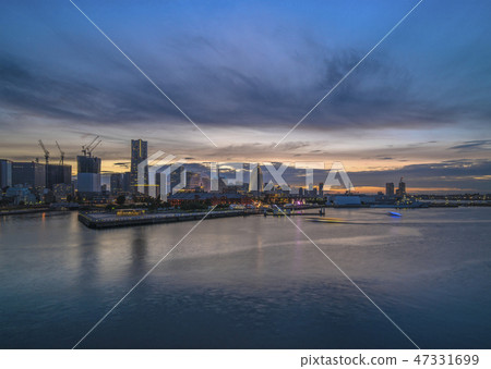 A sunset setting in Minato Mirai in Yokohama seen from Oosan Bridge. A sunset setting in Minato Mirai in Yokohama seen from Oosan Bridge. 47331699