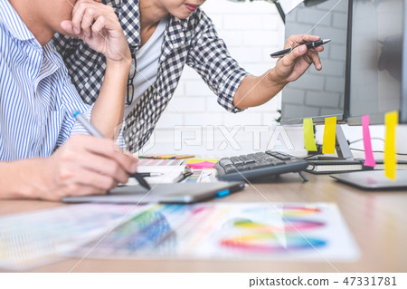 Two colleagues creative graphic designer working on color select Two colleagues creative graphic designer working on color select 47331781