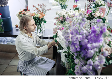 Profile photo of attentive florist that taking bouquet Profile photo of attentive florist that taking bouquet 47332012