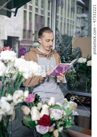 Concentrated male person studying info about cultivar Concentrated male person studying info about cultivar 47332221