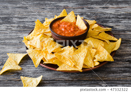 Nachos corn chips with spicy tomato sauce. Nachos corn chips with spicy tomato sauce. 47332322