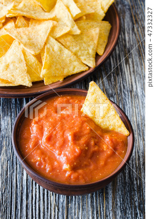 Nachos corn chips, spicy tomato and cheese sauces. Nachos corn chips, spicy tomato and cheese sauces. 47332327