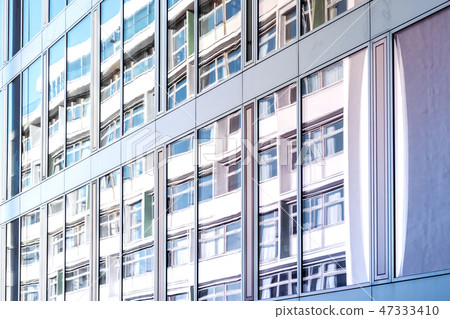 building reflection on glass facade, modern office 47333410