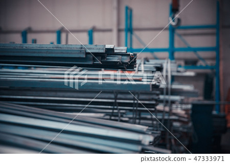 long and short steel pipes lay on shop rack 47333971