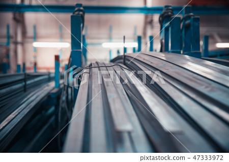 long and short steel pipes lay on shop rack 47333972