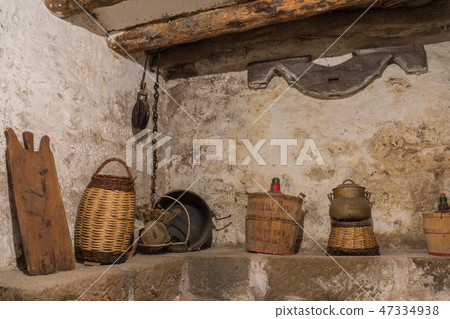 Basement old house wooden beams, antique household, carboy demijohn, stewpot, plank, Wicker basket Basement old house wooden beams, antique household, carboy demijohn, stewpot, plank, Wicker basket 47334938