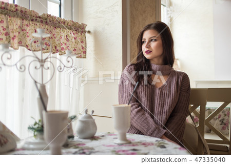 Young beautiful girl in cozy cafe Young beautiful girl in cozy cafe 47335040