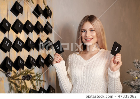 The girl is holding a calendar sheet. 31th of December. New Year's Eve. The girl is holding a calendar sheet. 31th of December. New Year's Eve. 47335062