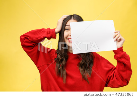 girl holds a white sheet in hands, an office worker shows a blank sheet. girl holds a white sheet in hands, an office worker shows a blank sheet. 47335065