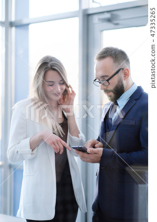 A man and a woman at the entrance to the office door are talking, acquaintance. A man and a woman at the entrance to the office door are talking, acquaintance. 47335265