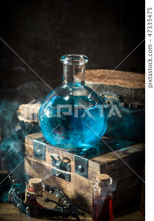 Blue magic potion with smoke Blue magic potion with smoke 47335475