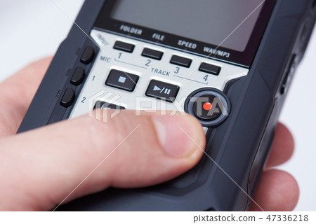 Audiorecorder in hand close up 47336218