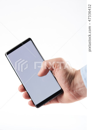 Holding modern smartphone in hand Holding modern smartphone in hand 47336432