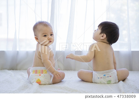 Little two cute babies photo. Baby wearing diaper in white bedroom. 121 Little two cute babies photo. Baby wearing diaper in white bedroom. 121 47338009