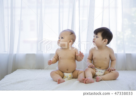 Little two cute babies photo. Baby wearing diaper in white bedroom. 148 Little two cute babies photo. Baby wearing diaper in white bedroom. 148 47338033