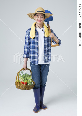 Agriculture industry, farming and people concept. Young farmer gesturing over gray background. 126 47338035