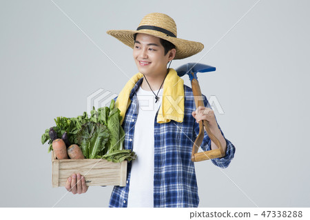 Agriculture industry, farming and people concept. Young farmer gesturing over gray background. 013 Agriculture industry, farming and people concept. Young farmer gesturing over gray background. 013 47338288