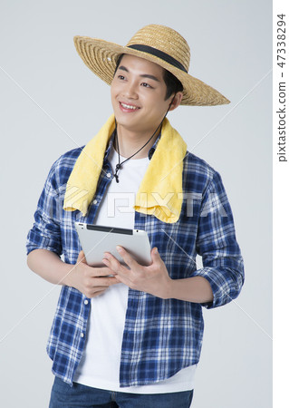 Agriculture industry, farming and people concept. Young farmer gesturing over gray background. 111 Agriculture industry, farming and people concept. Young farmer gesturing over gray background. 111 47338294