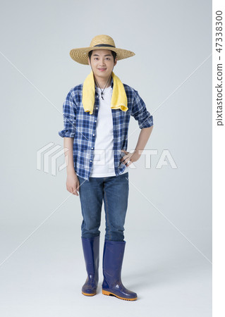 Agriculture industry, farming and people concept. Young farmer gesturing over gray background. 001 Agriculture industry, farming and people concept. Young farmer gesturing over gray background. 001 47338300