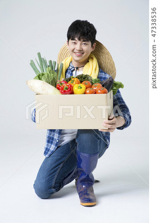 Agriculture industry, farming and people concept. Young farmer gesturing over gray background. 107 Agriculture industry, farming and people concept. Young farmer gesturing over gray background. 107 47338536
