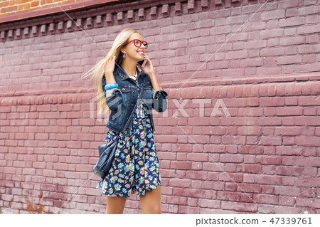 Young woman walking down the street 47339761