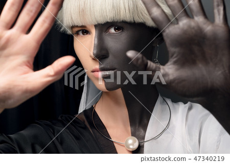 Portrait of a girl half black and white. Half-breed, mixing races, African and european. 47340219