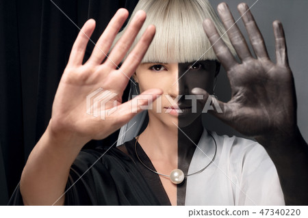 Portrait of a girl half black and white. Half-breed, mixing races, African and european. 47340220