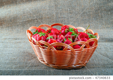 Ripe juicy strawberries in wicker basket. Ripe juicy strawberries in wicker basket. 47340633