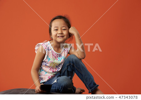 Little asian kid with smartphone Little asian kid with smartphone 47343078