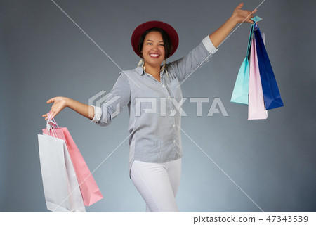 Happy woman with colorful shopping bags Happy woman with colorful shopping bags 47343539