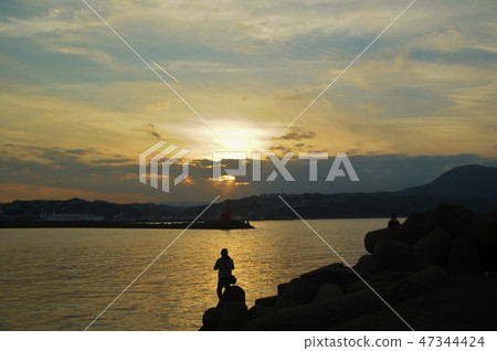 Fisherman at dusk 47344424