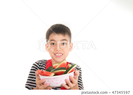 Little boys eat watermelon on white Little boys eat watermelon on white 47345597