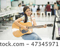 Asian girl studyguitar in the music classroom 47345971