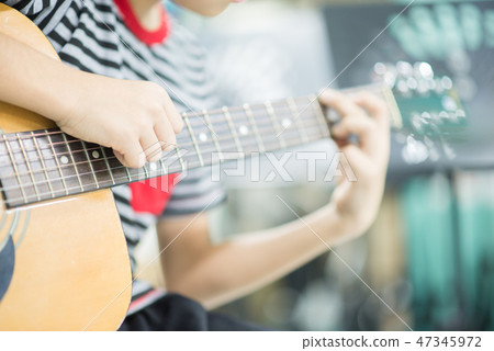 Asian girl studyguitar in the music classroom Asian girl studyguitar in the music classroom 47345972