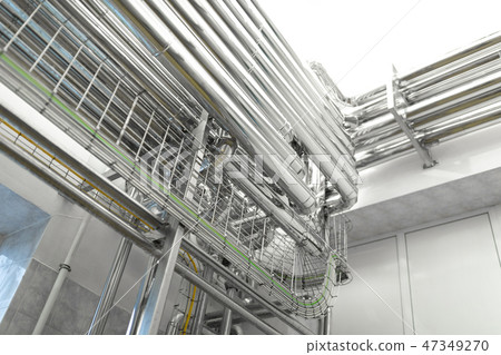 Steel pipelines and cables in factory interior as chemical industry background concept 47349270