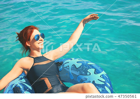 Woman relax on inflatable ring in sea water 47350561