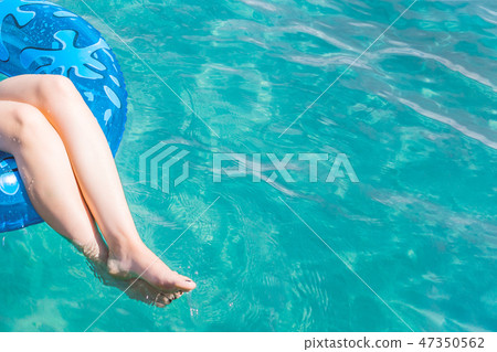 Woman relax on inflatable ring in sea water 47350562