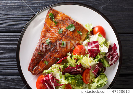 Fried pike fillet served with fresh vegetable Fried pike fillet served with fresh vegetable 47350613
