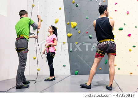 Woman preparing for wall climbing 47350917