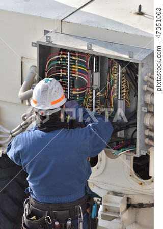 Electrical worker working on switchboard Electrical worker working on switchboard 47351008