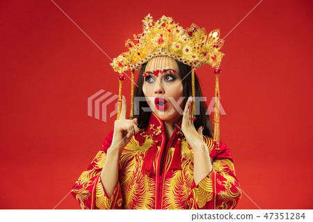 Chinese traditional woman. Beautiful young girl wearing in national costume Chinese traditional woman. Beautiful young girl wearing in national costume 47351284