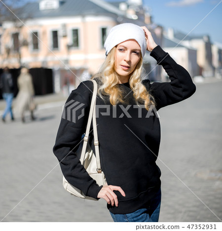 Street fashion look. Beautiful girl in black hoody Street fashion look. Beautiful girl in black hoody 47352931