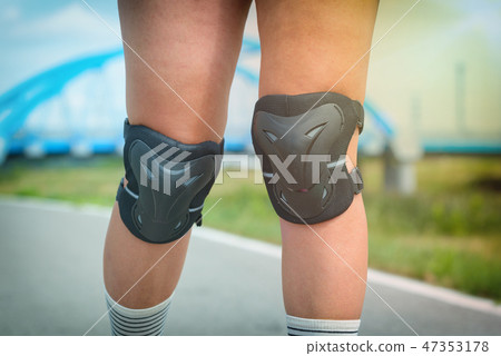 Woman rollerskater wearing knee protector pads Woman rollerskater wearing knee protector pads 47353178