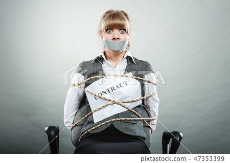 Businesswoman bound by contract with taped mouth. 47353399